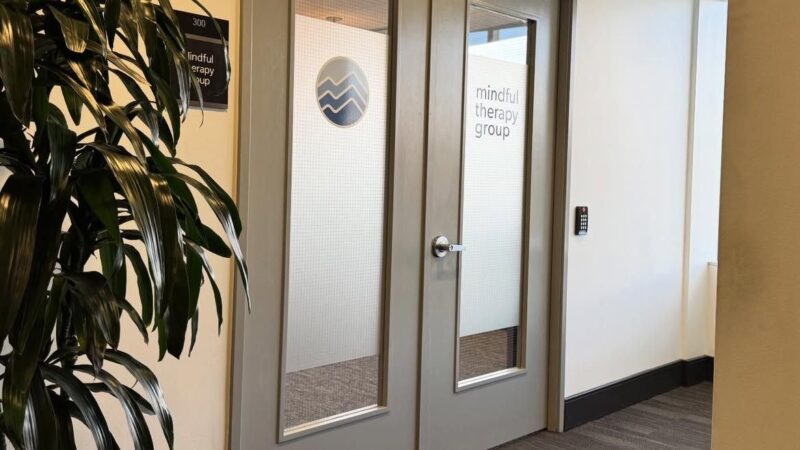 Decorative privacy film with custom branding on office glass